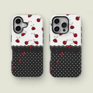 May include: Two phone cases with a ladybug design. The top half of the cases is white with red ladybugs. The bottom half is black with white polka dots, separated by a black scalloped edge.