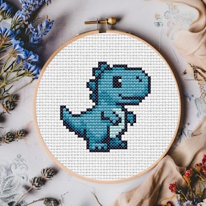 May include: A blue and white cross-stitch pattern of a cartoon dinosaur in a hoop.