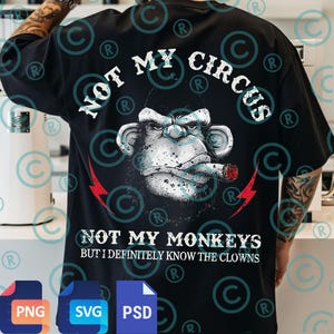May include: Black t-shirt featuring a detailed illustration of a monkey smoking a cigar, with the text "NOT MY CIRCUS" above and "NOT MY MONKEYS BUT I DEFINITELY KNOW THE CLOWNS" below. Red lightning bolt graphics flank the monkey image.