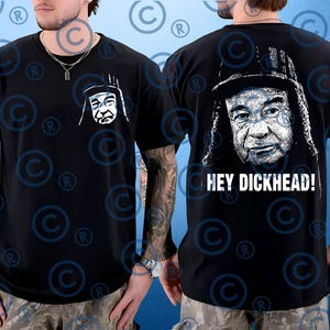 May include: Black t-shirt featuring a white graphic on the front and back. The front graphic is a stylized face. The back graphic is a portrait with the text "HEY DICKHEAD!" below it. The shirt has short sleeves.