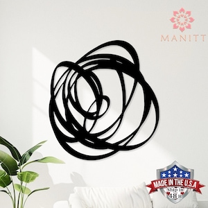 May include: Black metal wall art featuring an abstract design of intertwined, flowing lines. The artwork is mounted on a white wall, creating a striking contrast. The piece is a modern, minimalist home decor item.