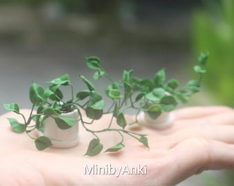 Miniature Pothos plant made from airdry clay in a ceramic/terracotta pot