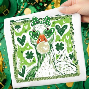 May include: White square St. Patrick's Day themed design featuring a goose wearing green shamrock glasses and a bow. The goose has an orange beak and is blowing a bubble. Green hearts and shamrocks surround the goose.