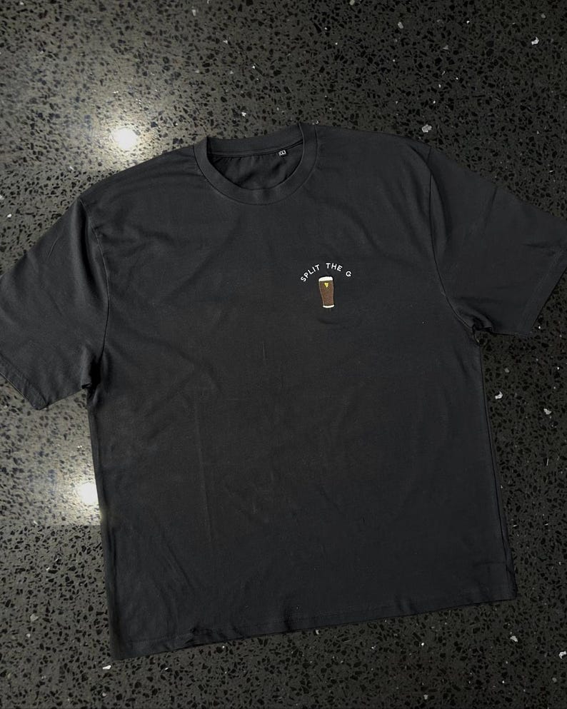 May include: Black t-shirt with a white graphic of a pint of beer and the text "Split the G".