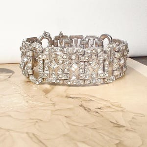 May include: A rustic wooden sign with the text "Welcome to our home" in white lettering. The sign features a distressed finish and a simple, inviting design, perfect for a front porch or entryway.