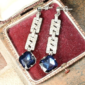 May include: A handmade, wooden cutting board with a natural finish. The board features a live edge on one side and a smooth, rectangular shape. It is approximately 18 inches long and 12 inches wide.