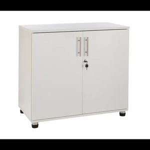 May include: White cabinet with two doors and a lock. The cabinet has silver handles and sits on four black feet.