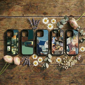 May include: Five phone cases with various artistic designs, including cityscapes, a diner scene, and collage art. The cases are black with colorful images, arranged on a rustic wooden surface with flowers and greenery.