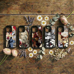 May include: Five black phone cases with unique designs featuring images from a musical. The cases showcase a variety of collages with masks, portraits, and floral accents. The cases are arranged on a rustic wooden surface.