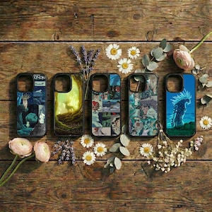 May include: Five phone cases with black borders and various anime-style illustrations. The cases feature images of characters and scenes from animated films. The cases are arranged on a rustic wooden surface, decorated with flowers and sprigs of lavender.