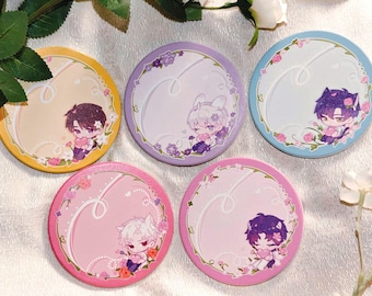 May include: Five round coasters with anime-style illustrations. Each coaster features a different color background: yellow, purple, blue, and two shades of pink. The coasters have floral borders and cartoon characters.
