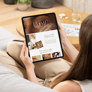 May include: A person holding a tablet displaying a website for Lume Medical Spa. The website features images of estheticians and spa services. The tablet is black and the person is wearing beige pants.
