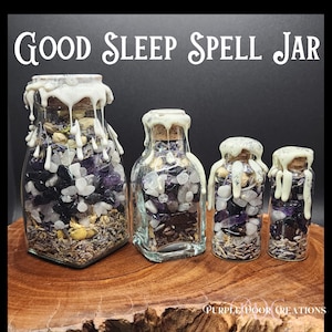 May include: Four glass jars filled with various crystals, herbs, and a white wax seal. The jars are labeled "GOOD SLEEP SPELL JAR".
