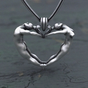 Sculptural heart design pendant with intertwined human figures