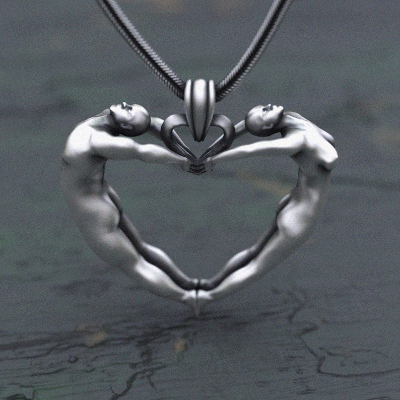 Sculptural heart design pendant with intertwined human figures
