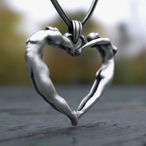 Artistic human form heart sculpture necklace in sterling silver