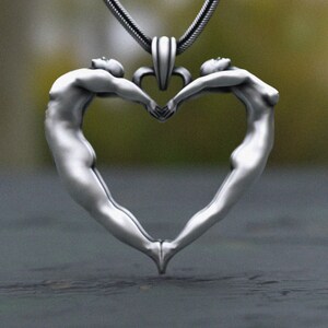 Detailed 925 silver pendant of human figures forming a heart