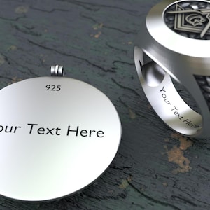 May include: A silver pendant and ring set. The pendant is round with the text "Your Text Here" and "925" engraved. The ring has a geometric design and the text "Your Text Here" inside the band. Both are on a textured surface.