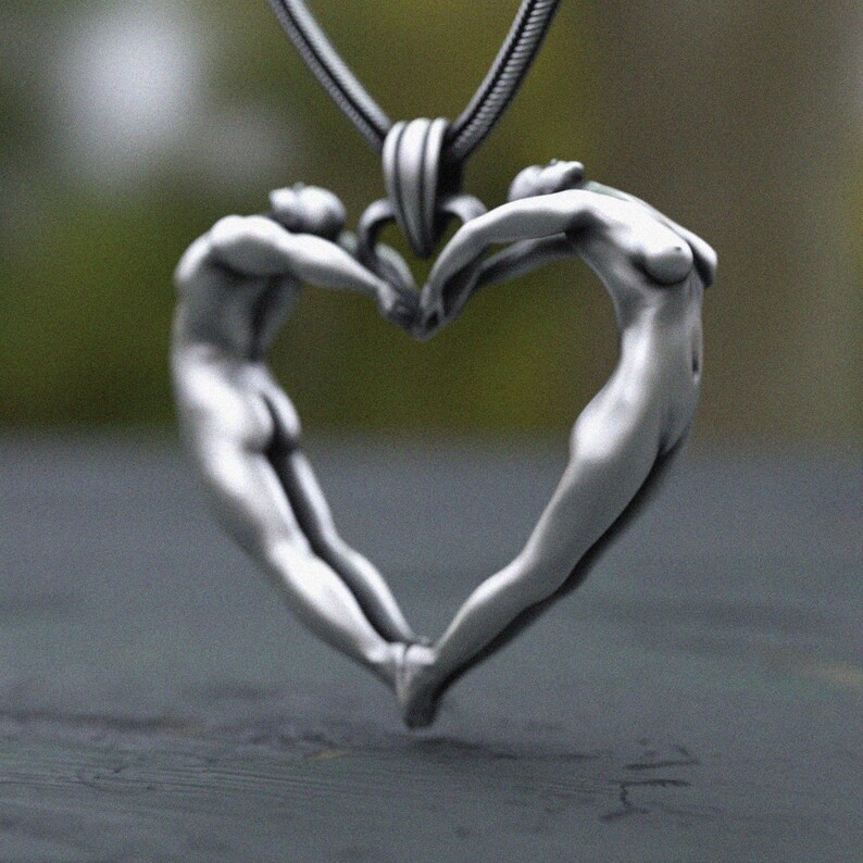 Handcrafted silver pendant depicting love through body shapes