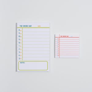 May include: A rectangular notepad and a square sticky note, both white with printed schedules. The larger notepad features blue text reading THE WORK DAY, yellow lines, and a notes section. The smaller square note has red text and lines.