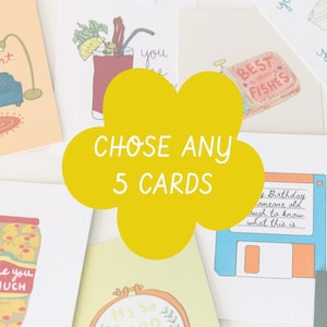 May include: A selection of greeting cards with various illustrations, including a cocktail, a sardine can labeled "BEST FISHES," and a floppy disk. A yellow flower shape in the center reads "CHOSE ANY 5 CARDS."