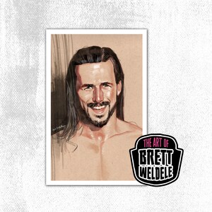 May include: A portrait print featuring a smiling man with long, dark hair and a beard. The artwork is in a sketch style with a neutral background. The print includes the text "The Art of Brett Weldele" in a black and pink logo.