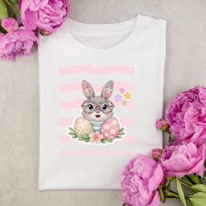 May include: A set of three ceramic mugs with a speckled, matte finish. The mugs are in shades of cream, light gray, and dark gray. Each mug has a simple, minimalist design and a rounded handle.