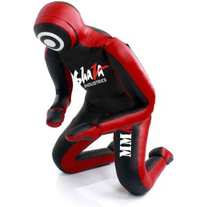 May include: A red and black training dummy kneeling with the text "Shaza Industries" and "MMA" on the torso.