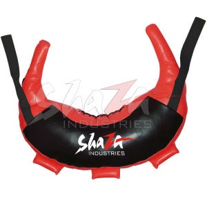 Op de afbeelding: Rode en zwarte trainingsapparatuur met de tekst "ShaZ Industries". De apparatuur heeft twee rode handvatten en een zwart middengedeelte. De apparatuur is ontworpen voor fitness- en vechtsporttraining.