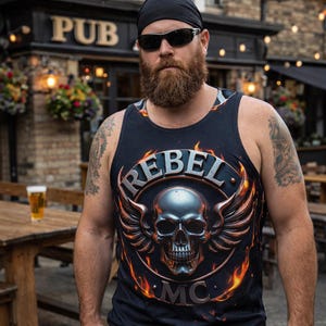May include: A black sleeveless tank top featuring a graphic print of a metallic skull with wings inside a circular frame. The text REBEL is arched above the skull, and MC is printed below. The design includes orange and yellow flame accents.