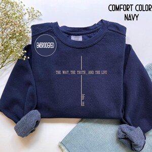 May include: Navy blue embroidered sweatshirt with the text "THE WAY, THE TRUTH, AND THE LIFE" and "John 14:6". The sweatshirt also has the words "COMFORT COLORS NAVY" on the top right.