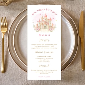 May include: A menu card for Amanda's birthday, featuring a pink castle illustration with floral accents. The menu includes starters, main courses, and desserts. Gold cutlery and a plate frame the card, with the date March 29, 20XX.