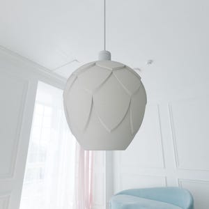 May include: White pendant light fixture with a unique, textured, flower-shaped shade.