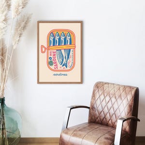 Tinned fish kitchen wall art in blue tones, great for coastal decor themes and unique housewarming gift ideas.
May include: A retro-style illustration of a can of sardines. The can is yellow with red and blue lettering. The text on the can reads 'We Sardine Sardine fillets in oil sardines'. The illustration is on a cream background with a wooden frame.