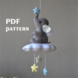 May include: PDF pattern for a felt baby mobile with a gray elephant holding a blue star, sitting on a white cloud with four hanging stars in yellow, blue, and white.