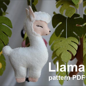 May include: A white felt llama with closed eyes, standing on a green felt background. The text "Llama pattern PDF" is visible below the llama.
