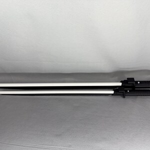 May include: Two black and white toy swords. The blades are white, and the handles are black with a textured grip. The swords are of different lengths, with the longer one measuring approximately 30 inches.