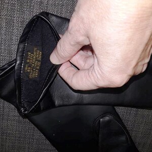 May include: Black vinyl glove with a soft lining. The label inside the glove reads "VINYL GLOVE, RN 54572, 100% NYLON FOURCHETTE, 100% NYLON LINING, FREE SIZE, JAPAN."