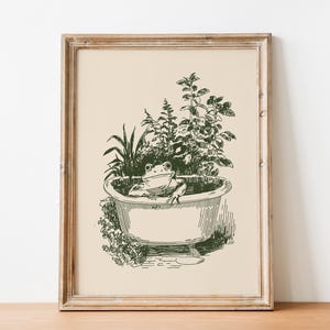 Ink-style drawing of a frog relaxing in a bathtub surrounded by leafy plants, with a soft vintage cottagecore look. Neutral simple art for guest bathroom decor.
