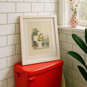 Hand drawn poster of a frog on toilet surrounded by plants, frog bathroom art for powder room art and restroom wall art, cute bathroom art with toilet humor art and bathroom humor sign vibe.