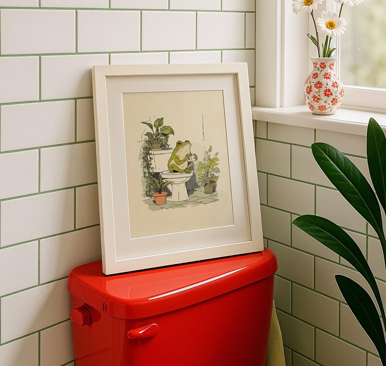 Hand drawn poster of a frog on toilet surrounded by plants, frog bathroom art for powder room art and restroom wall art, cute bathroom art with toilet humor art and bathroom humor sign vibe.