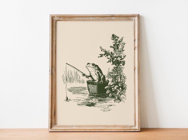 Hand drawn poster of a fishing frog sitting in a bucket by the water, ink drawing with vintage line art style, frog wall art for lake house decor, cabin decor, and fishing wall art.