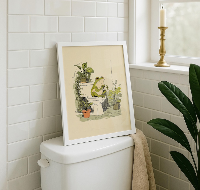 Hand drawn poster of a frog on toilet surrounded by plants, frog bathroom art for powder room art and restroom wall art, cute bathroom art with toilet humor art and bathroom humor sign vibe.