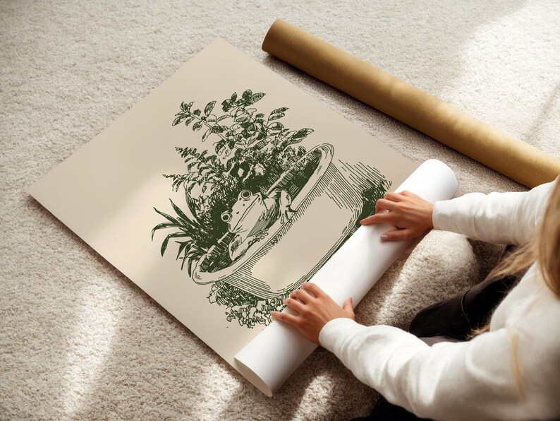 Ink-style drawing of a frog relaxing in a bathtub surrounded by leafy plants, with a soft vintage cottagecore look. Neutral simple art for guest bathroom decor.