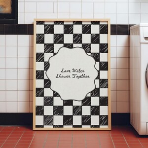 Funny "Save Water, Shower Together" bathroom wall art featuring a hand-drawn red and cream checkered pattern in a retro indie aesthetic.
