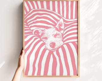 May include: A framed art print featuring a dog illustration. The dog is nestled in a striped pink and white blanket. The artwork is in a wooden frame, and the dog's eyes are closed. The overall theme is cozy and comforting.