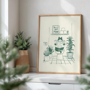 Minimal green line art illustration of a cute cat reading a newspaper on a toilet with potted plants and a “Have a Nice Poop” sign, funny bathroom art poster.