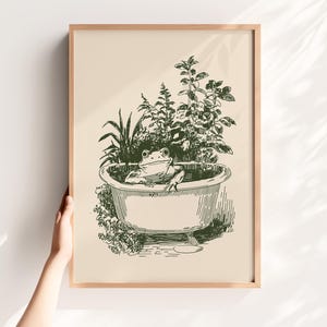 Ink-style drawing of a frog relaxing in a bathtub surrounded by leafy plants, with a soft vintage cottagecore look. Neutral simple art for guest bathroom decor.