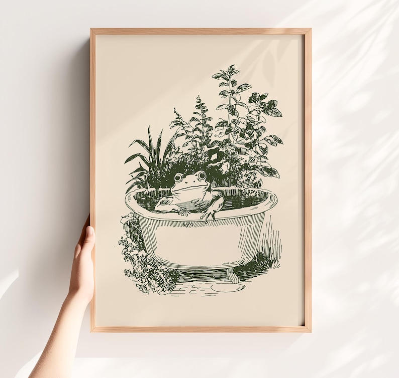 Ink-style drawing of a frog relaxing in a bathtub surrounded by leafy plants, with a soft vintage cottagecore look. Neutral simple art for guest bathroom decor.