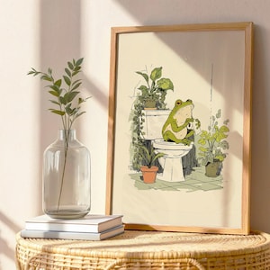 Hand drawn poster of a frog on toilet surrounded by plants, frog bathroom art for powder room art and restroom wall art, cute bathroom art with toilet humor art and bathroom humor sign vibe.